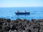 The jagged rocks at the shore near our hotel .. and the fisherman before they tried to land