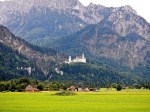 Neuschwanstein Castle dwarfed by the high mountains 