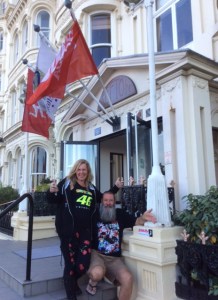 Jackie & Gary outside their hotel with the calling card stuck to the entry 