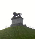 You can just see the globe on which his right paw rests 